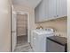 This laundry room has a washer and dryer, lots of storage, and access to a pantry at 15849 N 46Th Pl, Phoenix, AZ 85032