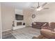 Cozy living room with tile floors, fireplace, comfortable seating, and ceiling fan at 15849 N 46Th Pl, Phoenix, AZ 85032