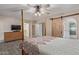 This main bedroom has wood floors and a sliding barn door to the ensuite bathroom at 15849 N 46Th Pl, Phoenix, AZ 85032