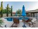 Inviting pool featuring lounge chairs, shade umbrellas, lush landscaping, and a tranquil atmosphere at 15849 N 46Th Pl, Phoenix, AZ 85032