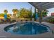 Inviting backyard pool with lounge chairs, manicured landscaping, and a covered patio area at 15849 N 46Th Pl, Phoenix, AZ 85032