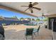 Inviting backyard features a covered patio with ceiling fans and a sparkling pool, great for outdoor living at 16396 W Fillmore St, Goodyear, AZ 85338