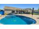 Backyard view of the house, pool, and patio showcasing an outdoor living and entertaining space at 16396 W Fillmore St, Goodyear, AZ 85338