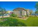 A well-manicured backyard with lush artificial turf and a sparkling pool in the background at 16396 W Fillmore St, Goodyear, AZ 85338