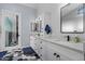 Chic bathroom boasts a double vanity, hexagon floor tiles, and modern black hardware at 16396 W Fillmore St, Goodyear, AZ 85338