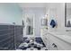 Bright bathroom features a double vanity, hexagon tiled floors, and stylish fixtures at 16396 W Fillmore St, Goodyear, AZ 85338