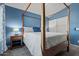 Primary bedroom featuring a four-poster bed, and a walk-in closet at 16396 W Fillmore St, Goodyear, AZ 85338