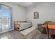 Bedroom featuring a daybed, a reading chair, and carpeted floors at 16396 W Fillmore St, Goodyear, AZ 85338