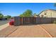 Property features a well-maintained wooden gate and easy access to the street at 16396 W Fillmore St, Goodyear, AZ 85338