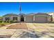 Charming single-Gathering home with landscaped front yard, a two-car garage, and an American flag at 16396 W Fillmore St, Goodyear, AZ 85338