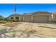 Property with a two-car garage, driveway, and landscaping beneath clear blue sky at 16396 W Fillmore St, Goodyear, AZ 85338