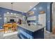 Bright kitchen featuring a blue island, dining area, and ample counter space and stainless steel appliances at 16396 W Fillmore St, Goodyear, AZ 85338