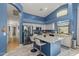 Modern kitchen with blue walls, white cabinets, a spacious island, and stainless steel appliances at 16396 W Fillmore St, Goodyear, AZ 85338