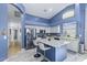 Bright kitchen featuring white cabinetry, stainless steel appliances, and a central island with bar seating at 16396 W Fillmore St, Goodyear, AZ 85338