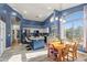 Bright kitchen featuring white cabinets, a blue island, and a breakfast nook with large windows at 16396 W Fillmore St, Goodyear, AZ 85338