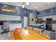 Stylish kitchen with white cabinets, a blue island, and a view of the dining area at 16396 W Fillmore St, Goodyear, AZ 85338