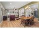 A shared living and dining room with hardwood floors and a view of the entryway at 16396 W Fillmore St, Goodyear, AZ 85338