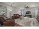 Spacious living room with recessed lighting, a ceiling fan, a large tv, and hardwood floors at 16396 W Fillmore St, Goodyear, AZ 85338