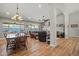 Open floor plan with a dining area and living room, featuring hardwood floors at 16396 W Fillmore St, Goodyear, AZ 85338
