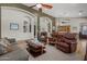 Spacious living room featuring comfortable seating, wood floors, and lots of natural light at 16396 W Fillmore St, Goodyear, AZ 85338