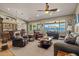 Open concept living and dining room with comfortable seating, wood floors, and natural light at 16396 W Fillmore St, Goodyear, AZ 85338