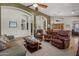 Open concept living and dining room with hardwood floors and neutral tones at 16396 W Fillmore St, Goodyear, AZ 85338
