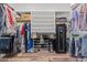 Spacious walk-in closet offering ample storage with rods, shelves, and a secure safe at 16396 W Fillmore St, Goodyear, AZ 85338