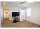 Upstairs bedroom with carpet, TV, closet, and a light filled window at 16425 W Latham St, Goodyear, AZ 85338