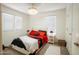 Cozy bedroom with red and black accents, including a luxurious bed and bedside tables at 16425 W Latham St, Goodyear, AZ 85338