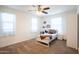 Bedroom featuring a twin bed, plush carpet, and natural lighting at 16425 W Latham St, Goodyear, AZ 85338
