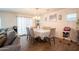 Bright dining area featuring a table with six chairs near a window with sheer curtains at 16425 W Latham St, Goodyear, AZ 85338