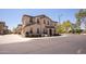 Inviting two-story townhome featuring a neutral stucco exterior with a covered entryway at 16425 W Latham St, Goodyear, AZ 85338