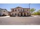 Charming two-story townhome with neutral stucco exterior and well-maintained landscaping at 16425 W Latham St, Goodyear, AZ 85338
