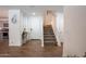 Inviting foyer featuring a staircase, stylish decor, and tile flooring that leads to the kitchen at 16425 W Latham St, Goodyear, AZ 85338