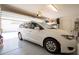 Spacious garage with ample lighting and storage, accommodating a white minivan and other belongings efficiently at 16425 W Latham St, Goodyear, AZ 85338