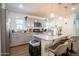 Modern kitchen featuring an island with seating, stainless steel appliances, and gray cabinets at 16425 W Latham St, Goodyear, AZ 85338