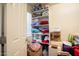 Linen closet with shelves filled with pillows, blankets, and suitcases at 16425 W Latham St, Goodyear, AZ 85338