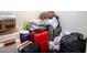 A storage room filled with suitcases, pillows, blankets, and shopping bags at 16425 W Latham St, Goodyear, AZ 85338