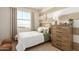 Charming bedroom features a striped accent wall, bright window, and cozy decor, perfect for restful nights at 18231 W Soft Wind Dr, Surprise, AZ 85387