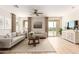 Bright and airy living room featuring a ceiling fan, tile floors, neutral walls, and comfortable seating arrangements at 18231 W Soft Wind Dr, Surprise, AZ 85387