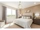 Sunlit main bedroom showcases a large window, paneled accent wall, and cozy decor for a relaxing atmosphere at 18231 W Soft Wind Dr, Surprise, AZ 85387
