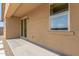 Covered patio with stucco walls, an outdoor light fixture, and a sliding glass door at 18231 W Soft Wind Dr, Surprise, AZ 85387