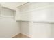 Spacious walk-in closet with ample shelving and rods, offering plenty of room for organized storage solutions at 18231 W Soft Wind Dr, Surprise, AZ 85387