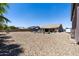 Wide view of the private backyard with a pool, desert landscaping, and outdoor living spaces at 18319 W Marshall Ave, Litchfield Park, AZ 85340