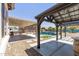 Relaxing backyard with covered patios, a pool, and outdoor kitchen at 18319 W Marshall Ave, Litchfield Park, AZ 85340