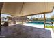 Backyard space with covered patio, outdoor kitchen, pool, and artificial turf accents at 18319 W Marshall Ave, Litchfield Park, AZ 85340