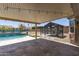 Inviting covered patio featuring a pool with waterfall and charming gazebo for outdoor relaxation at 18319 W Marshall Ave, Litchfield Park, AZ 85340