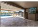 Spacious covered patio offers a seamless transition to a serene backyard with a pool and outdoor television at 18319 W Marshall Ave, Litchfield Park, AZ 85340