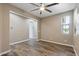 Bedroom featuring light filled window, ceiling fan and hardwood flooring at 18319 W Marshall Ave, Litchfield Park, AZ 85340
