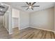 Spacious bedroom featuring wood floors, ceiling fan, and a walk-in closet at 18319 W Marshall Ave, Litchfield Park, AZ 85340